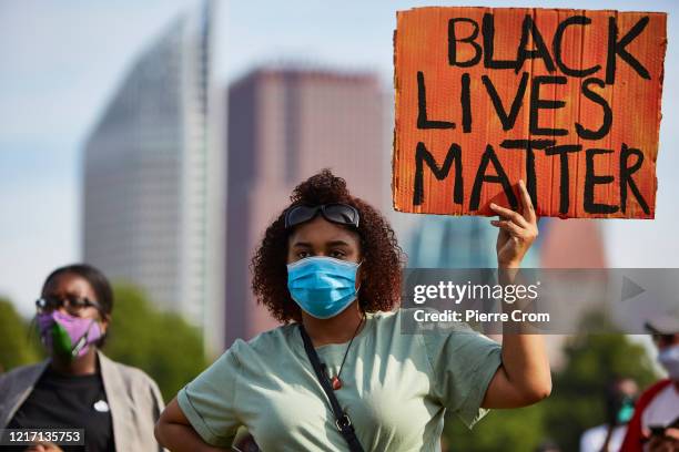 Protester holds a sign in protest as people gather on Malieveld in The Hague to attend a solidarity rally against racism in the aftermath of the...