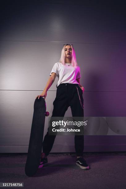 portrait of girl holding skateboard - fashionable girl stock pictures, royalty-free photos & images