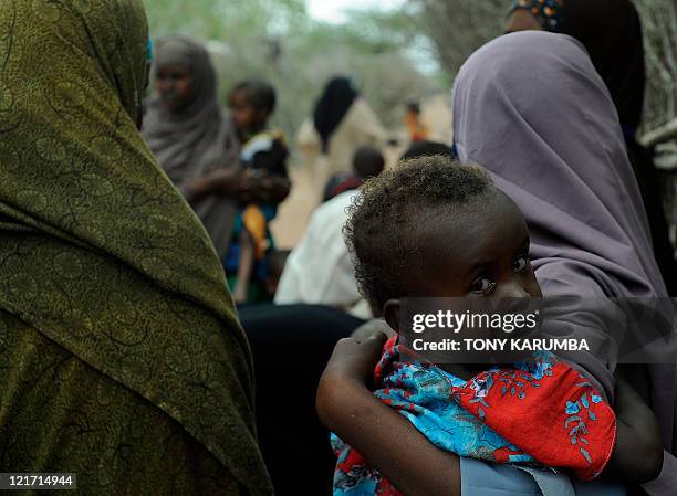 Young Somali refugee waits with her mother to be vaccinated at a paediatric vaccination centre at Hagadere refugee site within the Dadaab refugee...