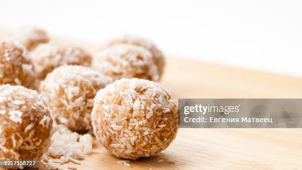 homemade handmade sweet candy balls in coconut shavings. healthy eating lifestyle concept - coconut biscuits stockfoto's en -beelden