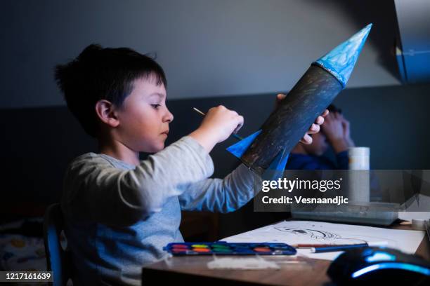 elementary age school boy making space rocket - model rocket stock pictures, royalty-free photos & images