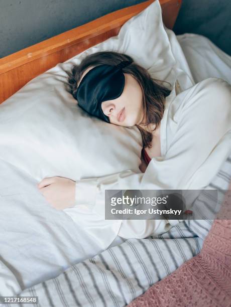 young beautiful woman sleeping peacefully - silk pillow stock-fotos und bilder
