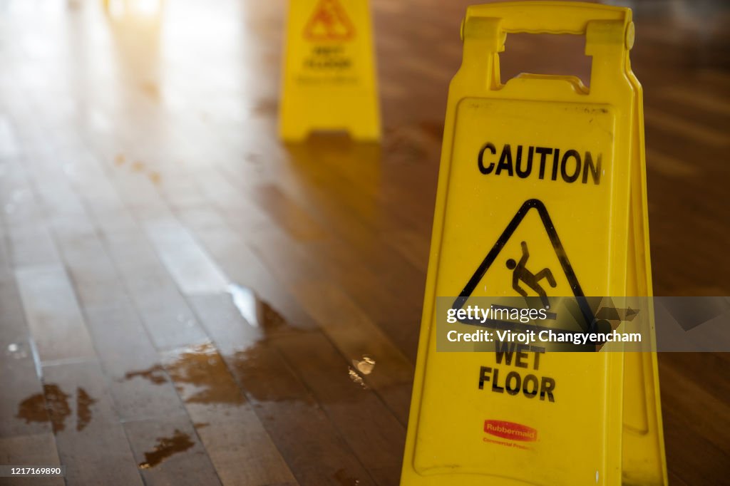 Wet floor sign on the floor in the store