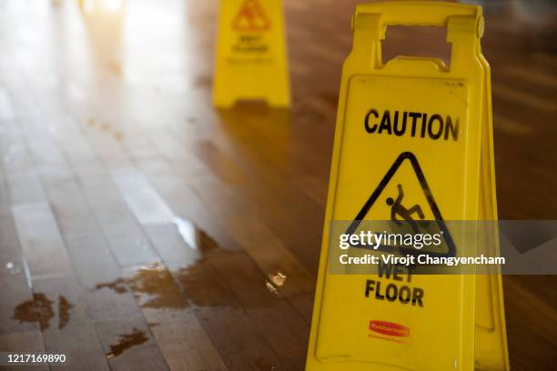 wet floor sign on the floor in the store - slippery stock pictures, royalty-free photos & images