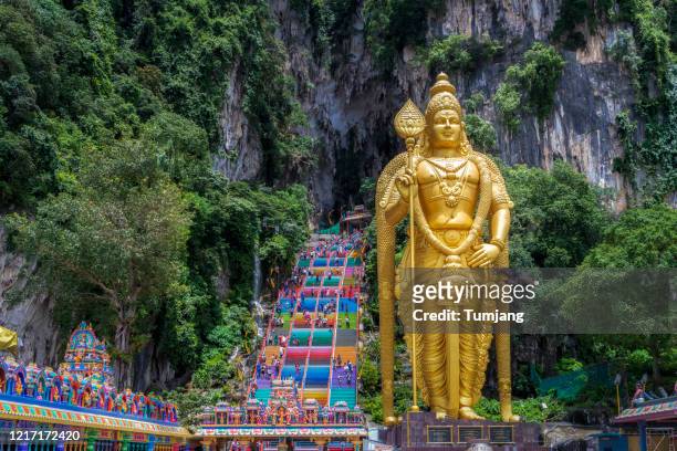 scenic view in the middle of a cavern at batu caves temple in kuala lumpur, malaysia - batu caves stock pictures, royalty-free photos & images