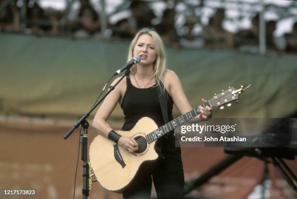 Jewel is shown performing on stage during her concert performance at Woodstock 99 on July 25, 1999.