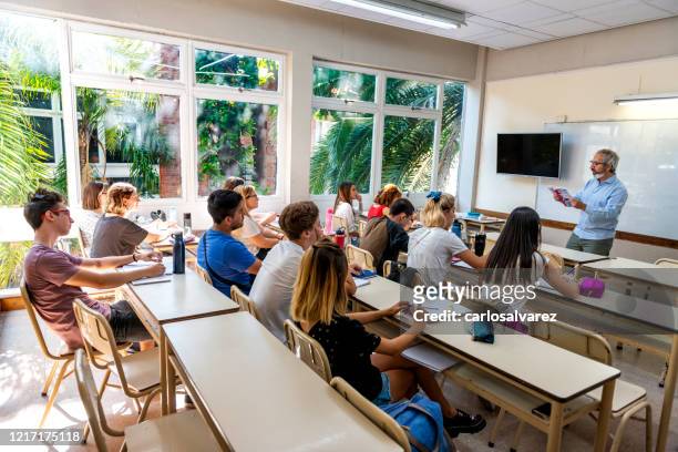 professor reads to a class - high school stock pictures, royalty-free photos & images