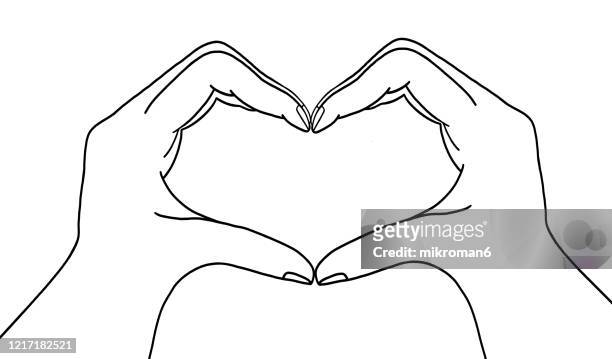 sketch hands showing heart shape - hand drawn love heart stock-fotos und bilder