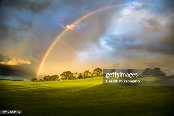 double rainbow landscape - arco iris doble fotografías e imágenes de stock