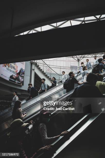crowded escalators at seoul station in south korea - seoul station stock pictures, royalty-free photos & images