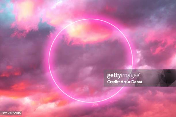 futuristic neon circle in the burning sky with stunning pink colors. - divine stockfoto's en -beelden