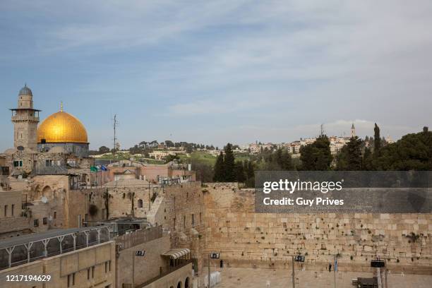 The Western Wall in the old city is empty, with the Dome of the Rock mosque in the distance during a government enforced lockdown due to the...