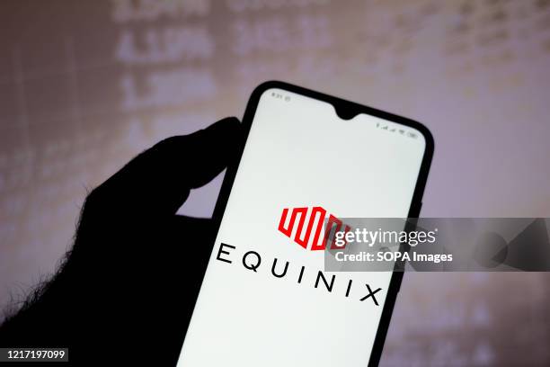 In this photo illustration the Equinix logo seen displayed on a smartphone.