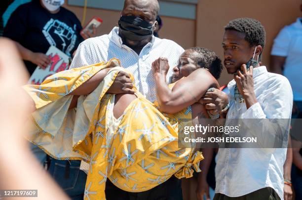 Sekyiwa Shakur, the sister of late rap artist Tupac Shakur, is carried away after speaking to protesters during a peaceful rally for George Floyd in...