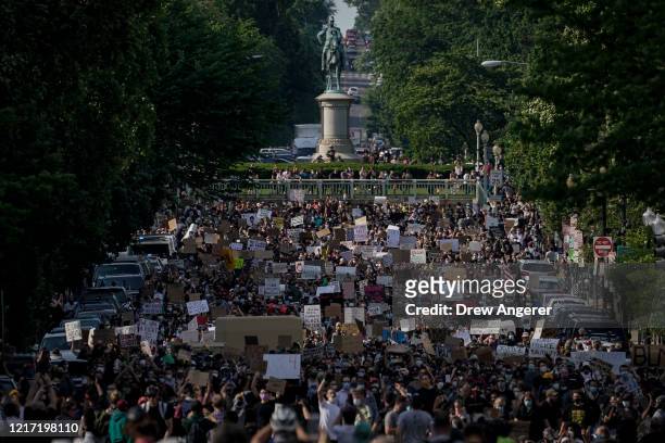 Hundreds of demonstrators march toward Lafayette Park and the White House to protest against police brutality and the death of George Floyd, on June...