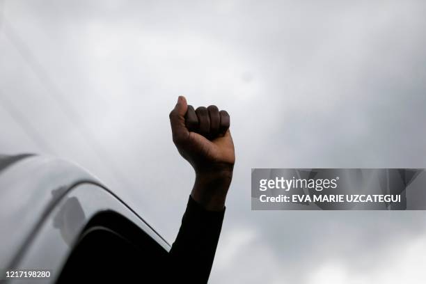 Demonstrator raises his fist during a protest against police brutality and the recent death of George Floyd in Sunrise, Florida on June 02, 2020. -...