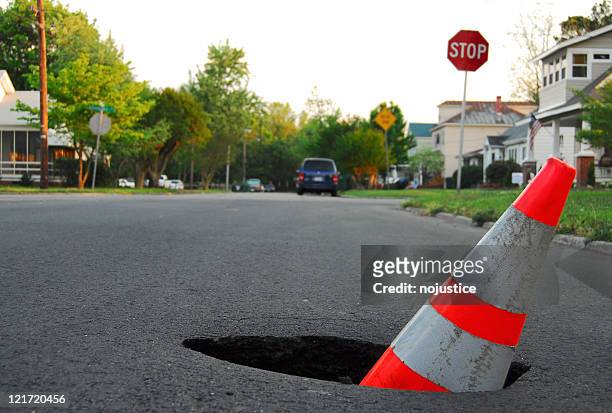 traffic hazard - pothole stockfoto's en -beelden
