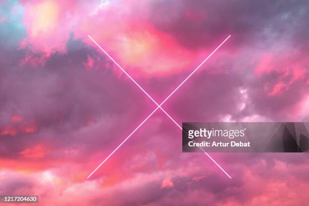 futuristic cross with neon lights in the burning sky with stunning pink colors. - letter x stock pictures, royalty-free photos & images