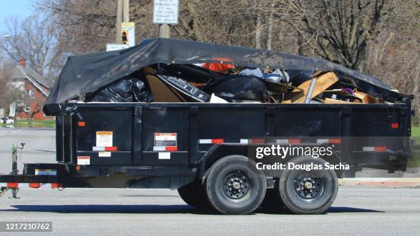 cargo trailer being pulled with garbage and debris - utility trailer stock pictures, royalty-free photos & images