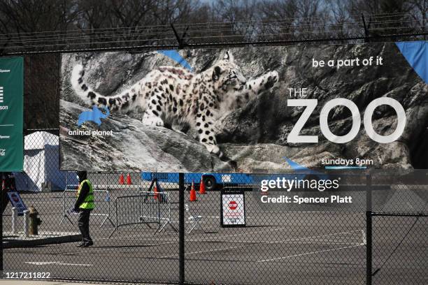 Poster hangs from a fence at the Bronx Zoo on April 06, 2020 in New York City. A tiger at the zoo has tested positive for COVID-19, the Wildlife...