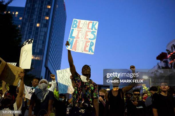 Protesters demonstrate during a peaceful march to mourn the death of George Floyd in downtown Houston, Texas on Tuesday, June 2, 2020. - Anti-racism...