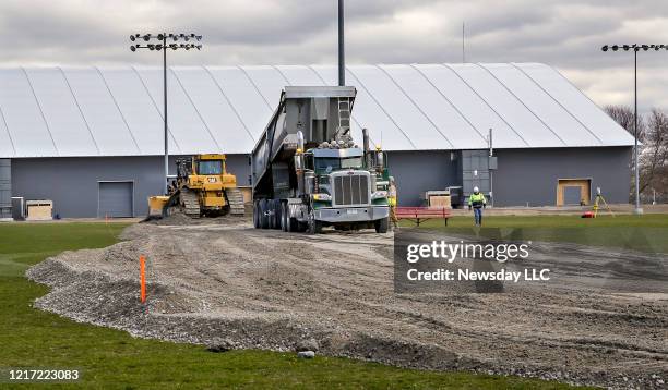 Workers are building a new road to access an athletic facility on the campus of Stony Brook University on Long Island on March 31, 2020. The work is...