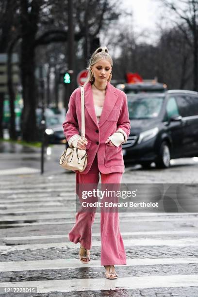 Victoria Magrath "Inthefrow" wears a necklace, golden earrings, a pink corduroy oversized jacket, a white low neck top with long sleeves, a white...