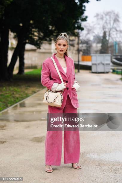Victoria Magrath "Inthefrow" wears a necklace, golden earrings, a pink corduroy oversized jacket, a white low neck top with long sleeves, a white...