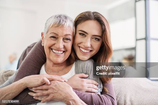 women are beautiful at all ages - granddaughter hug stock pictures, royalty-free photos & images