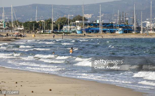People enjoy swimming at a beach as Tunisia lifts more coronavirus restrictions in Hammamet, Tunisia on June 2, 2020. Tunisia will open its sea, land...