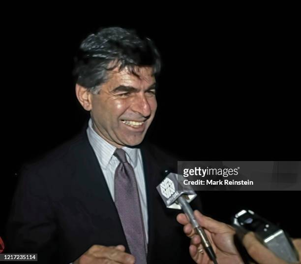 Democratic Presidential candidate Governor Michael Dukakis talks to a radio reporter on a farm in rural Illinois during a campaign stop on his swing...