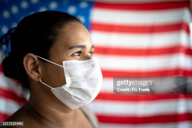 woman with face mask and american flag on background - state of emergency stock pictures, royalty-free photos & images