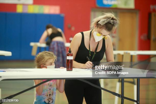 Woman wearing a face mask is seen voting during Indiana Primary Election Day. Primary Elections take place in Bloomington, Indiana after polls closed...