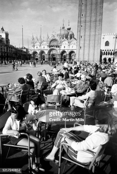 American comedienne, actress, singer and businesswoman Edie Adams , Elizabeth Kovacs and Kippie Kovacs sit at a café in front of St Mark's Basilica...