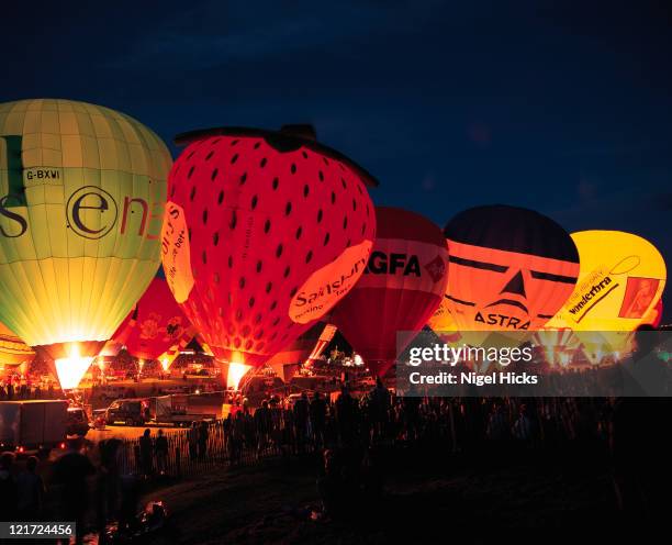 night time display at the ballon fiesta in august - bristol balloon stock pictures, royalty-free photos & images