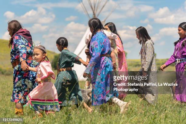 a group of native american females walking on the greasy grass - sioux culture bildbanksfoton och bilder