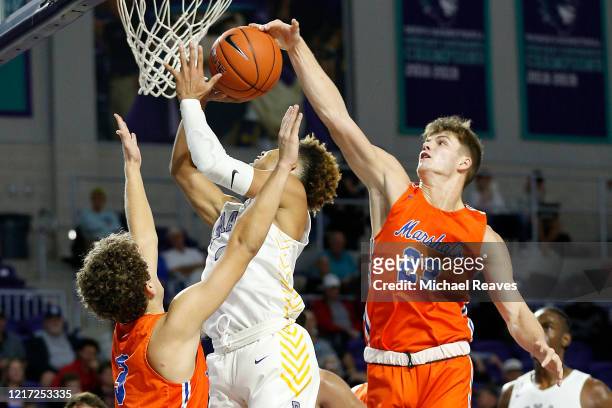 Tyler Stokes of Marshall County High School blocks a shot by Lynn Greer of Roman Catholic High School during the City of Palms Classic at Suncoast...