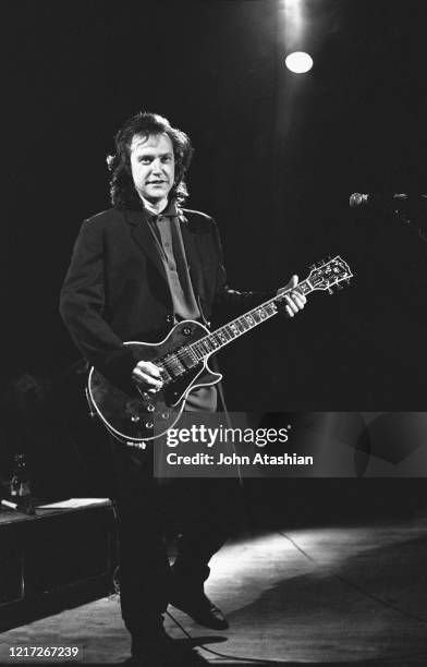 Guitarist and singer Dave Davies is shown performing on stage during a "live" concert appearance with The Kinks on April 1, 1988.