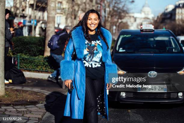 Model Paloma Elsesser wears a blue Saks Potts coat with fur lining, black graphic t-shirt, and black pants after the Lanvin show during Paris Fashion...