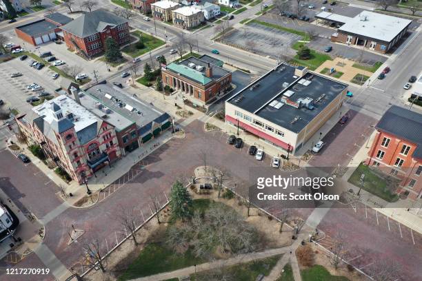 An aerial view from a drone shows few cars in the town square on April 06, 2020 in Woodstock, Illinois. Most of the small businesses in the town...