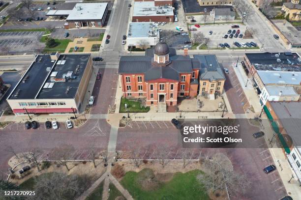An aerial view from a drone shows few cars in the town square on April 06, 2020 in Woodstock, Illinois. Most of the small businesses in the town...