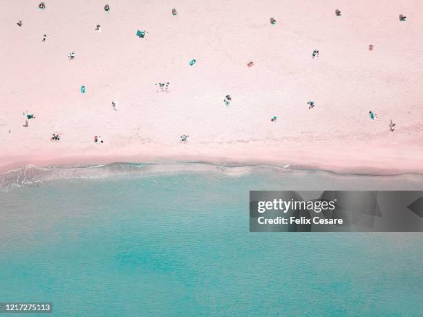 aerial view of people social distancing at the beach - cairns aerial foto e immagini stock