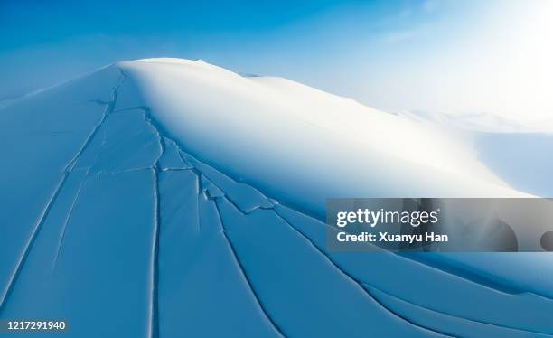 the sand dunes is covered with snow in winter - crevice stock pictures, royalty-free photos & images