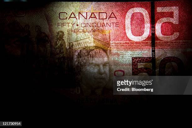 Canadian fifty dollar bill is arranged for a photograph in Toronto, Ontario, Canada, on Thursday, Aug. 18, 2011. The Canadian dollar advanced against...