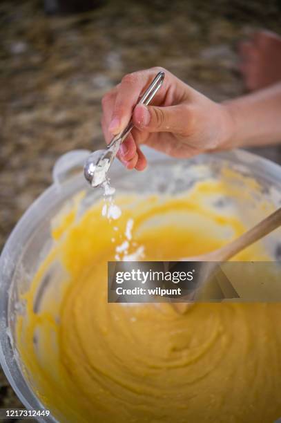 add baking powder soda to the mix close-up high angle view - baking soda stock pictures, royalty-free photos & images