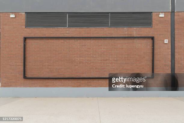 blank billboard on the brick wall - street wall stockfoto's en -beelden
