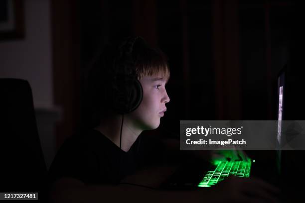 boy focused on playing an online game - bad habit stock pictures, royalty-free photos & images