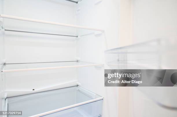 empty refrigerator with open door. - refrigerator stock pictures, royalty-free photos & images