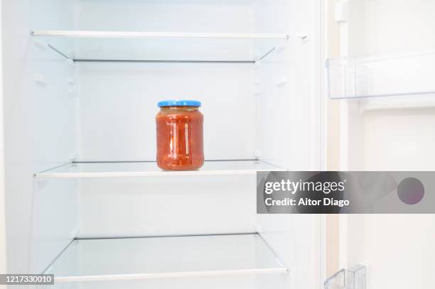 pot of tomatoes in a fridge. - einmachglas leer stock-fotos und bilder