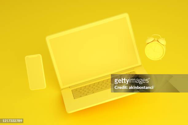 flying empty screen laptop and smart phone on yellow background, zero gravity - zero gravity imagens e fotografias de stock